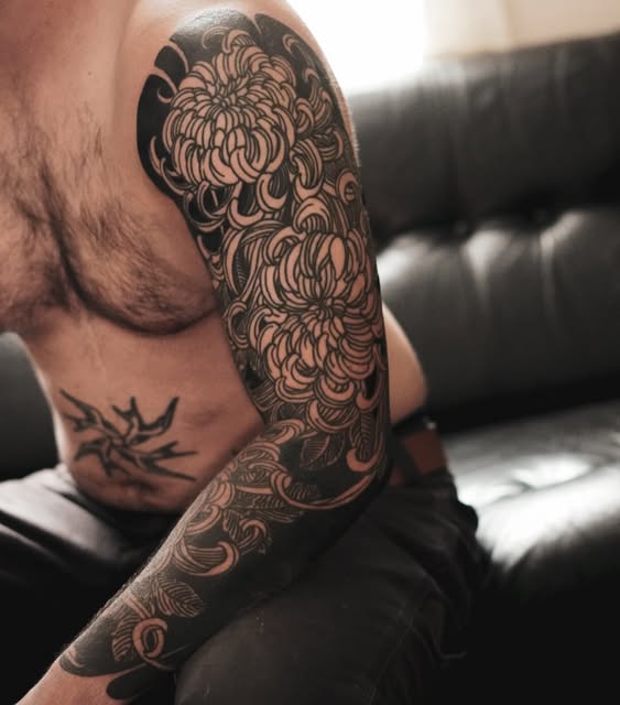 Dense floral tattoo covering an arm