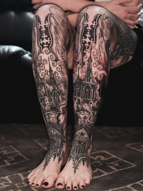 Paired architectural tattoo compositions across both lower legs